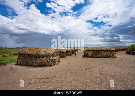 Exterior of straw huts in a Masai Village. Maasai an ethnic group of semi-nomadic people. Photographed in Serengeti, Tanzania Stock Photo