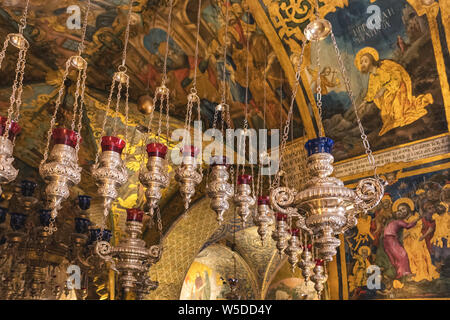 Old candle lamps and ceiling of the hall of the Golgotha altar in the Church of the Holy Sepulchre in Jerusalem, Israel