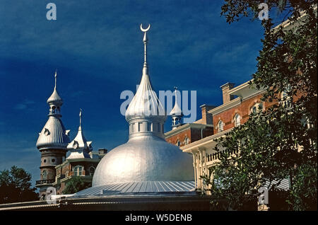 Dazzling silver minarets are eye-catching architectural features of the University of Tampa, which originally was the opulent Tampa Bay Hotel that opened in 1891 in Tampa, Florida, USA. Now renamed Plant Hall, the grand brick structure was the creation of railroad and steamship baron, Henry B. Plant, who offered hotel guests the most modern 19th-Century amenities, including electric lights, elevators, private baths and in-room telephones. The enormous building has 13 minarets, each topped with the Islamic symbol of a crescent moon. This Moorish/Victorian masterpiece took two years to build. Stock Photo