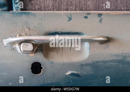 Abandoned car with missing lock part. Stock Photo