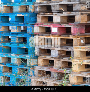 Old wooden pallets from cargo, shipping. Discarded, stacked. Stock Photo