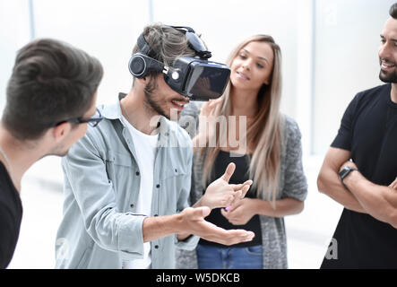 Positive colleagues testing virtual reality glasses Stock Photo