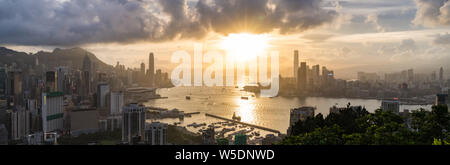Panoramic landscape or cityscape of Hong Kong island, Victoria harbour, and Kowloon city at sunset, view from Red incense burner summit. Asia travel