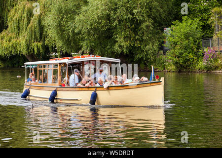 Holidaymakers onboard a pleasure boat giving boat day trips on the river Avon  as it passes through Stratford upon Avon in Warwickshire England Stock Photo