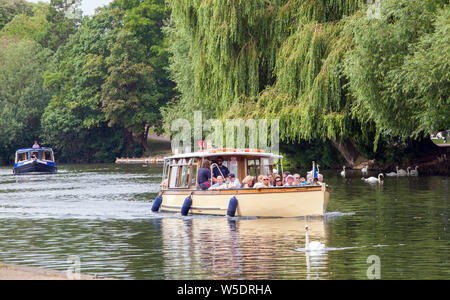 Holidaymakers onboard a pleasure boat giving boat day trips on the river Avon  as it passes through Stratford upon Avon in Warwickshire England Stock Photo