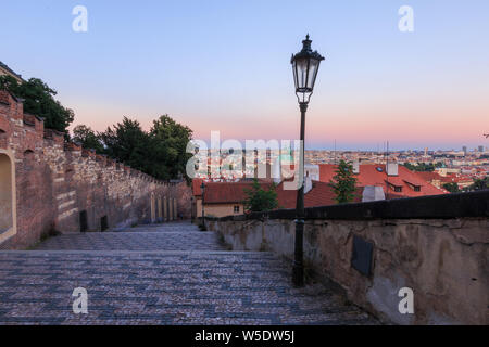 City view over the rooftops of the old town of Prague in the evening. Steps from the Prague Castle down to the district Lesser Town. Historic masonry Stock Photo