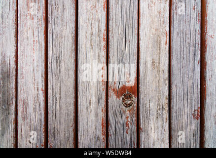 Weathered wooden laths with cracks and remains of exfoliated reddish brown paint, shabby look (close-up, landscape horizontal format) Stock Photo