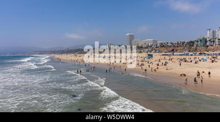 California USA. May 30, 2019. People on sandy Santa Monica beach. Pacific ocean coastline Los Angeles. Blue sky and sea Stock Photo