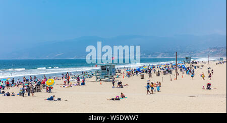 California USA. May 30, 2019. People on sandy Santa Monica beach. Pacific ocean coastline Los Angeles. Blue sky and sea Stock Photo