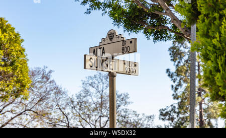 Los Angeles California, USA. May 31, 2019. Sunset Bl. and Alta crossing in Beverly hills. White road signs blue sky background. Sunny spring day. Stock Photo