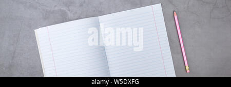 Flat lay, top view, notebook, pencil on a gray textured background Stock Photo