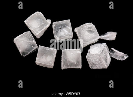 Cubes of Ice isolated on black Background, pieces of crushed ice with Snow on Top Stock Photo