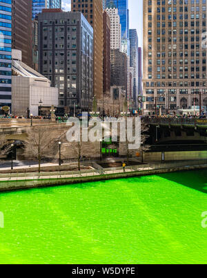 Chicago Skylines building along green dyeing river of Chicago River on St. Patrick day festival in Chicago Downtown IL USA Stock Photo