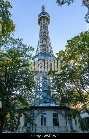 Metal observation tower on the hill Petrin in the Czech capital Prague with two platforms. Former radio tower in the park with the trees in the evenin Stock Photo