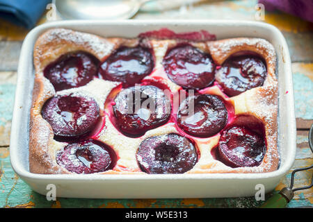 French clafoutis with plums and icing sugar Stock Photo