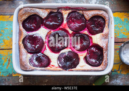 French clafoutis with plums and icing sugar Stock Photo