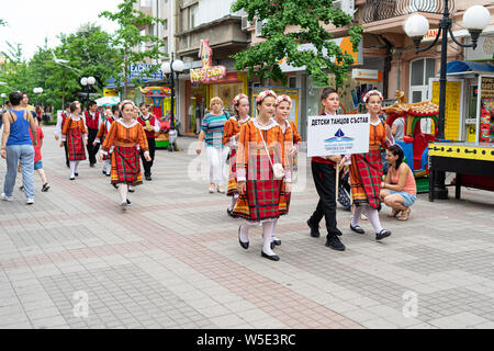 POMORIE, BULGARIA - JUNE 21, 2019: A group of children in Bulgarian national costumes on the streets. Stock Photo