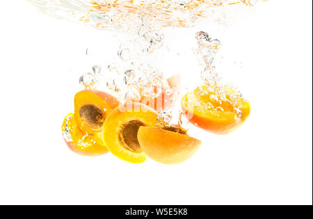 Fresh Nectarine with water splash isolated over white background. Health concept Stock Photo