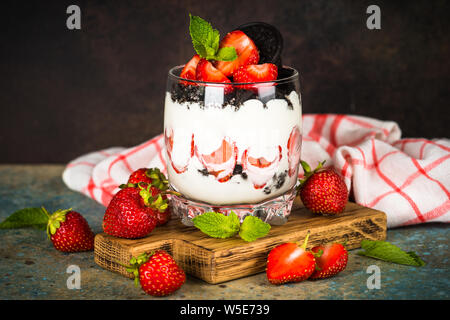 Strawberry dessert parfait with yogurt and chocolate cookies. Stock Photo