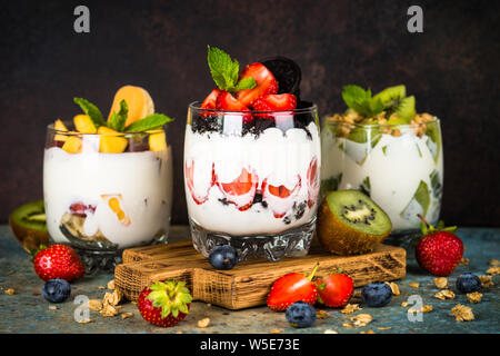 Fruit Dessert in glasses with yogurt and berries. Stock Photo