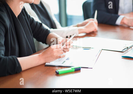 Business people discussing financial reports at meeting table Stock Photo