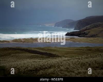 Sandwood Bay, Sutherland coast of NW Scotland. Known for its remote 1 mile long beach, near Cape Wrath. Beyond the large dunes lies a freshwater loch. Stock Photo