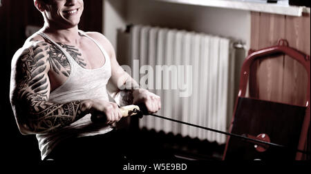 sporty handsome man doing exercises on the home trainer.healthy lifestyle Stock Photo