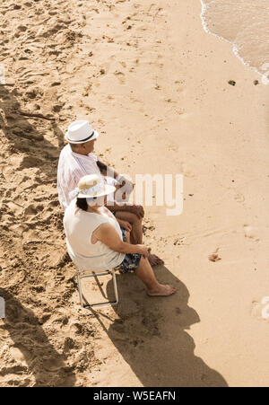 Elderly couple on beach in Spain. Stock Photo