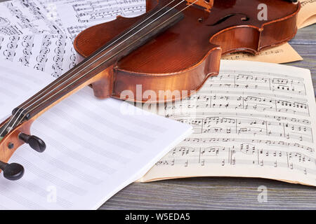 Sheets of musical symbols and violin. Stock Photo