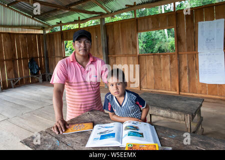 Warmi Isla Village Schoolhouse and Teacher on the Peruvian Amazon Stock Photo