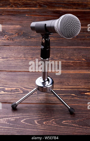 Microphone on brown wooden background. Stock Photo