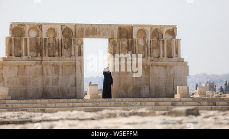 muslim woman in traditional dress takes a selfie on the citadel in Amman, Jordan. Stock Photo