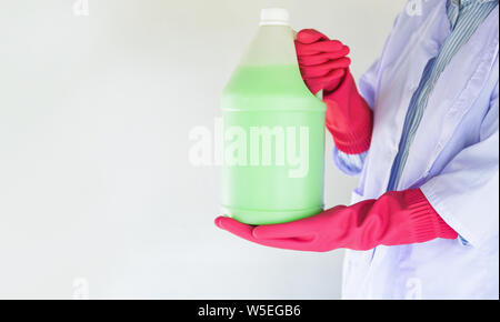 bottle liquid to clean dust on the floor , disinfectant floor cleaner solution for mop / woman maid hold the bottle of  bathroom cleaning liquid Stock Photo