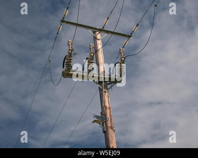 Electric power line showing insulators on a poll Stock Photo - Alamy