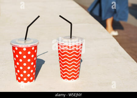 Two cocktails in disposable paper cups. Coffee and lemonade to go take away. Concept of a walk together Stock Photo