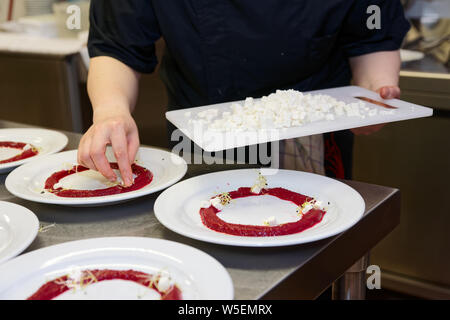 Chef is cooking set of appetizers, putting soft cheese Stock Photo
