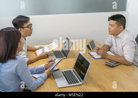 Asian businesspeople having discussion in meeting room Stock Photo