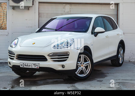 Novosibirsk, Russia - 07.25.2019: Front view of Porsche Cayenne 958 2008 in white color after cleaning before sale in a summer day on parking backgrou Stock Photo