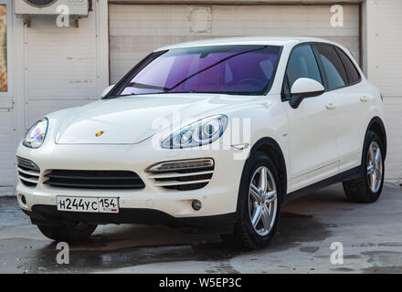 Novosibirsk, Russia - 07.25.2019: Front view of Porsche Cayenne 958 2008 in white color after cleaning before sale in a summer day on parking backgrou Stock Photo