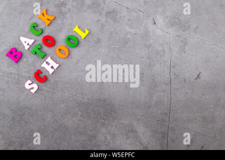 The layout of school supplies on a dark gray background. The view from the top. Back to school. Flat lay Stock Photo