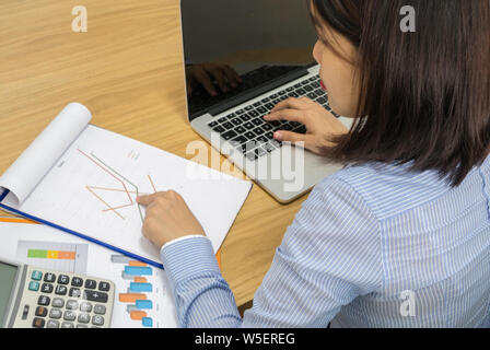 Office employee checking financial number on the document Stock Photo