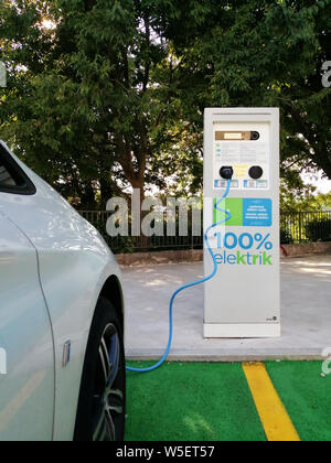 Electric car charging at a charging station Stock Photo