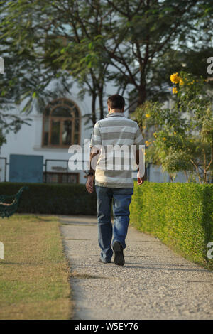 Rear view of an Indian man walking in a park Stock Photo