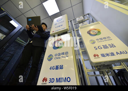 A Chinese worker tests equipments at Tianjin's first 5G base station in the China Mobile joint innovation center Tianjin open laboratory in Tianjin, C Stock Photo