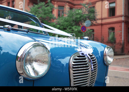 Close up of front of blue Austin A35 oldtimer car with round headlights and front grille parking in city Stock Photo