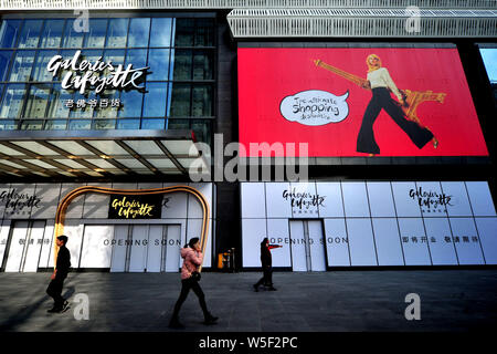 --FILE--Pedestrians walk past the soon-to-open China's second Galeries Lafayette department store in Shanghai, China, 24 December 2018.   French depar Stock Photo