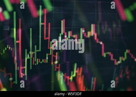 Close up of abstract business chart bars and arrows on dark background with binary code. Stock Photo