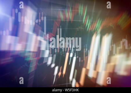 Close up of abstract business chart bars and arrows on dark background with binary code. Stock Photo