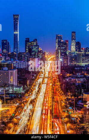 A night view of the busy roads with masses of vehicles in front of the CITIC Tower and other skyscrapers in the CBD (Central Business District) in Bei Stock Photo