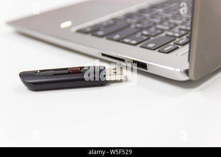 flash drive with laptop computer for conncet to USB port plug-in Laptop for transfer and backup business Stock Photo